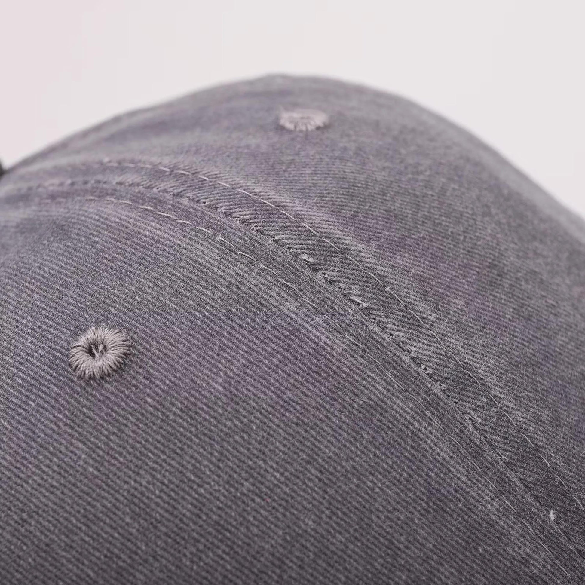 Close-up of the textured twill fabric and stitched panel on the cap