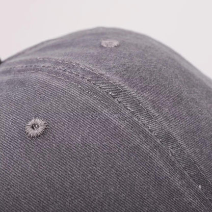 Close-up of the textured twill fabric and stitched panel on the cap