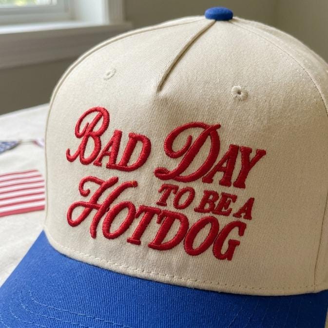 Close-up of red embroidered “Bad Day to Be a Hotdog” cap lettering