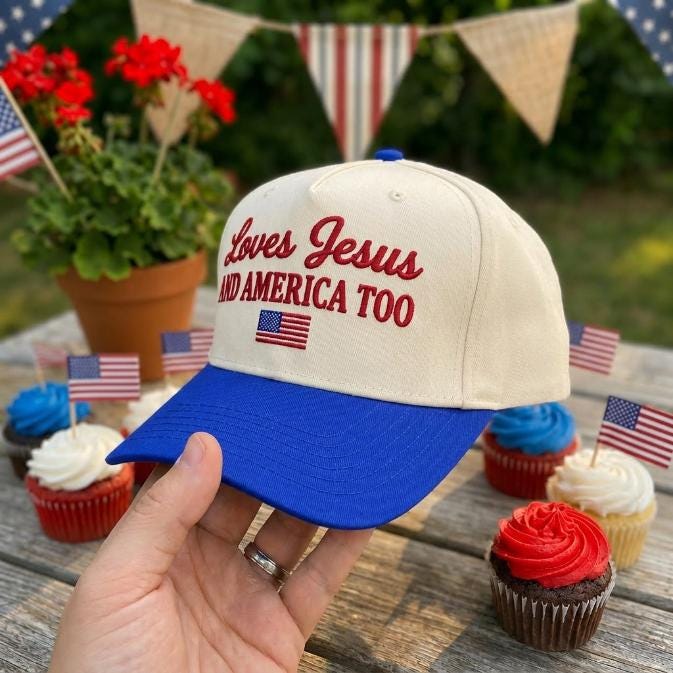 Angled view of the embroidered faith and patriotic two-tone cap with cream crown and blue bill