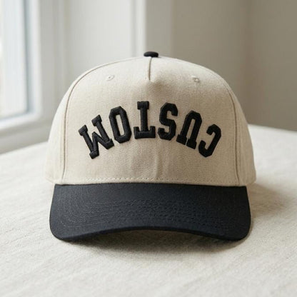 Beige trucker hat with black brim and raised black CUSTOM lettering