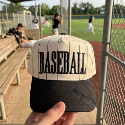 Pinstripe BASEBALL hat displayed beside a youth baseball field