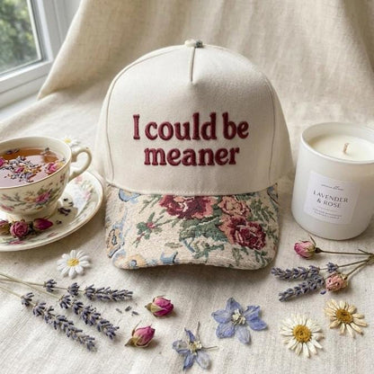 Front view of floral brim hat with humorous embroidered statement