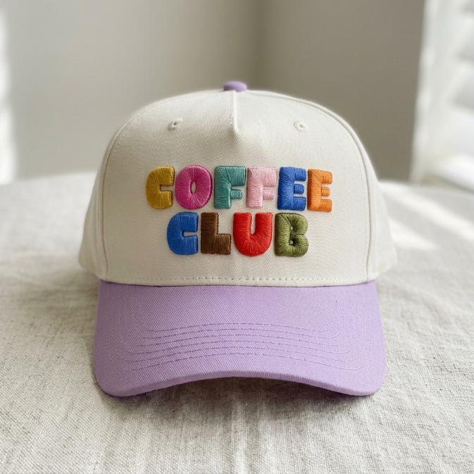 Front view of cream and lavender hat with multicolor Coffee Club embroidery