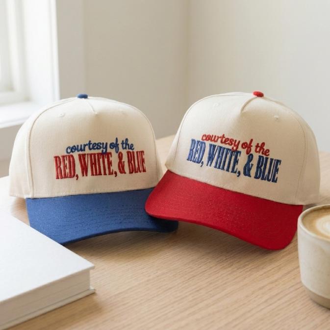 Close-up of red and blue brim trucker hats with patriotic embroidered front text