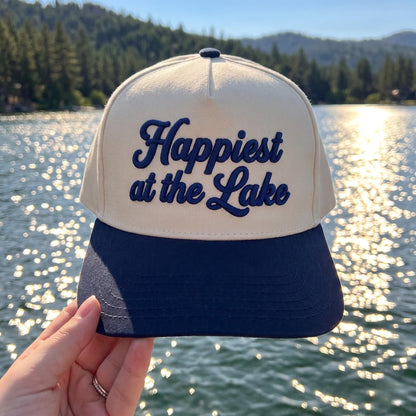 Cream and navy two-tone Happiest at the Lake embroidered hat by a scenic lake