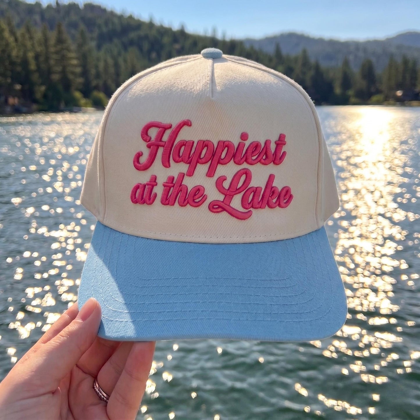 Cream and pink two-tone Happiest at the Lake embroidered hat by a scenic lake