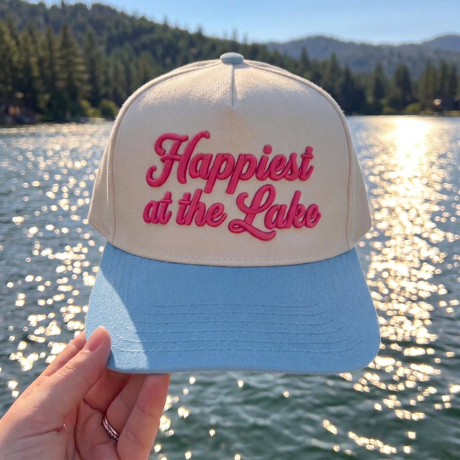 Cream and pink two-tone Happiest at the Lake embroidered hat by a scenic lake