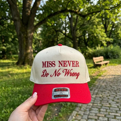 Cream and red two-tone trucker hat embroidered with Miss Never Do No Wrong