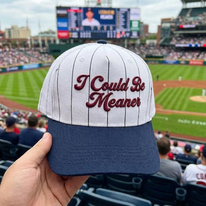 White and navy pinstripe hat embroidered with the phrase I Could Be Meaner