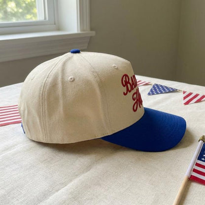 Side view of the two-tone cap with blue bill and cream crown