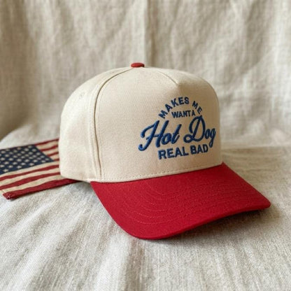 Angled view of two-tone trucker hat with blue embroidered hot dog lettering