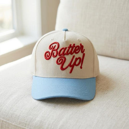 Front view of cream and light blue trucker cap with red “Bater Up!” embroidery
