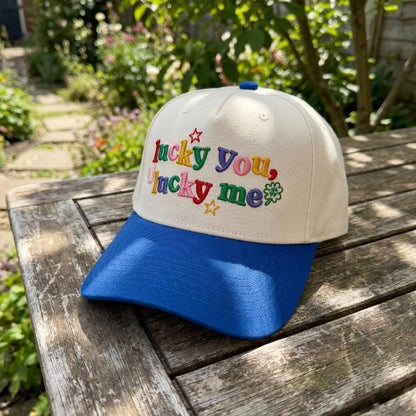 Angled view of the embroidered Lucky You Lucky Me two-tone hat with blue brim