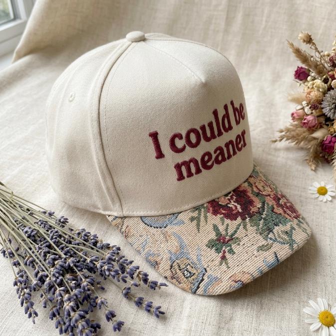 Angled view of cream hat showing floral brim and front embroidery