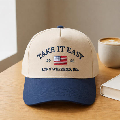 Angled view of the Take It Easy USA embroidered two-tone trucker hat with navy curved bill