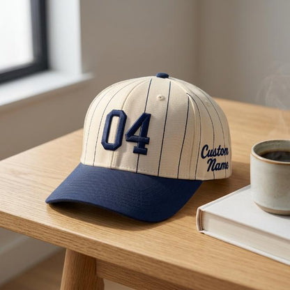 Personalized pinstripe baseball hat with navy brim displayed on a wooden table