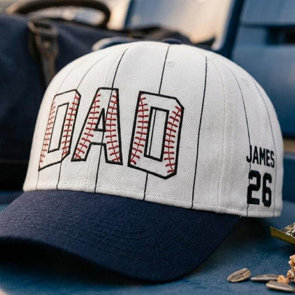 Close-up of DAL baseball lettering and James 26 side graphic on pinstripe hat