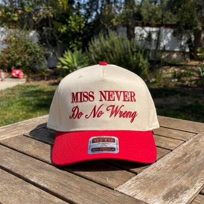 Front view of a cream crown and red bill embroidered trucker cap