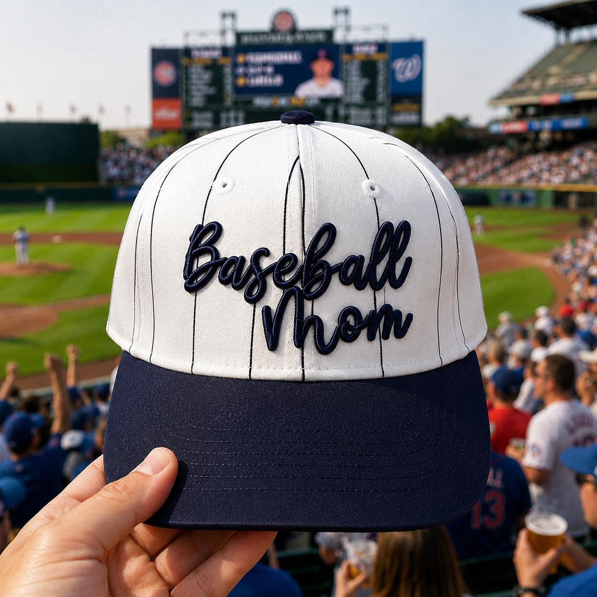 Front view of a white pinstripe Baseball Mom hat with navy embroidered lettering