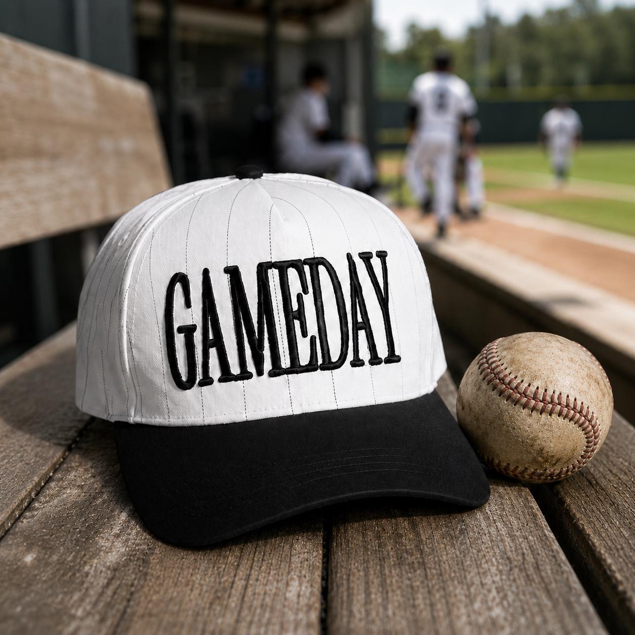 Game Day pinstripe hat displayed beside a baseball at a ballpark