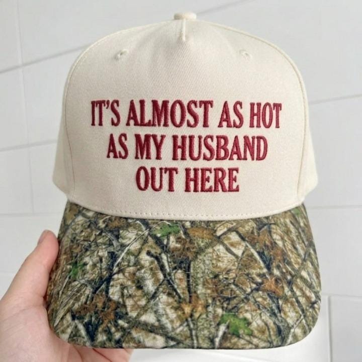Front view of embroidered humor hat with cream crown and camouflage brim