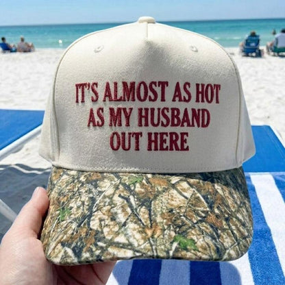 Cream embroidered hat with husband joke and camouflage-print brim at the beach