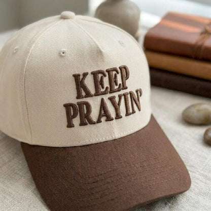 Angled view of two-tone Keep Prayin’ embroidered hat