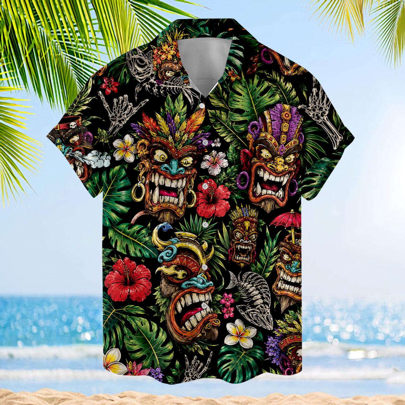 Front view of a tropical tiki mask Hawaiian shirt displayed against a beach background