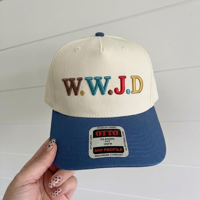 Two-tone cream and blue trucker hat with colorful W.W.J.D embroidered lettering