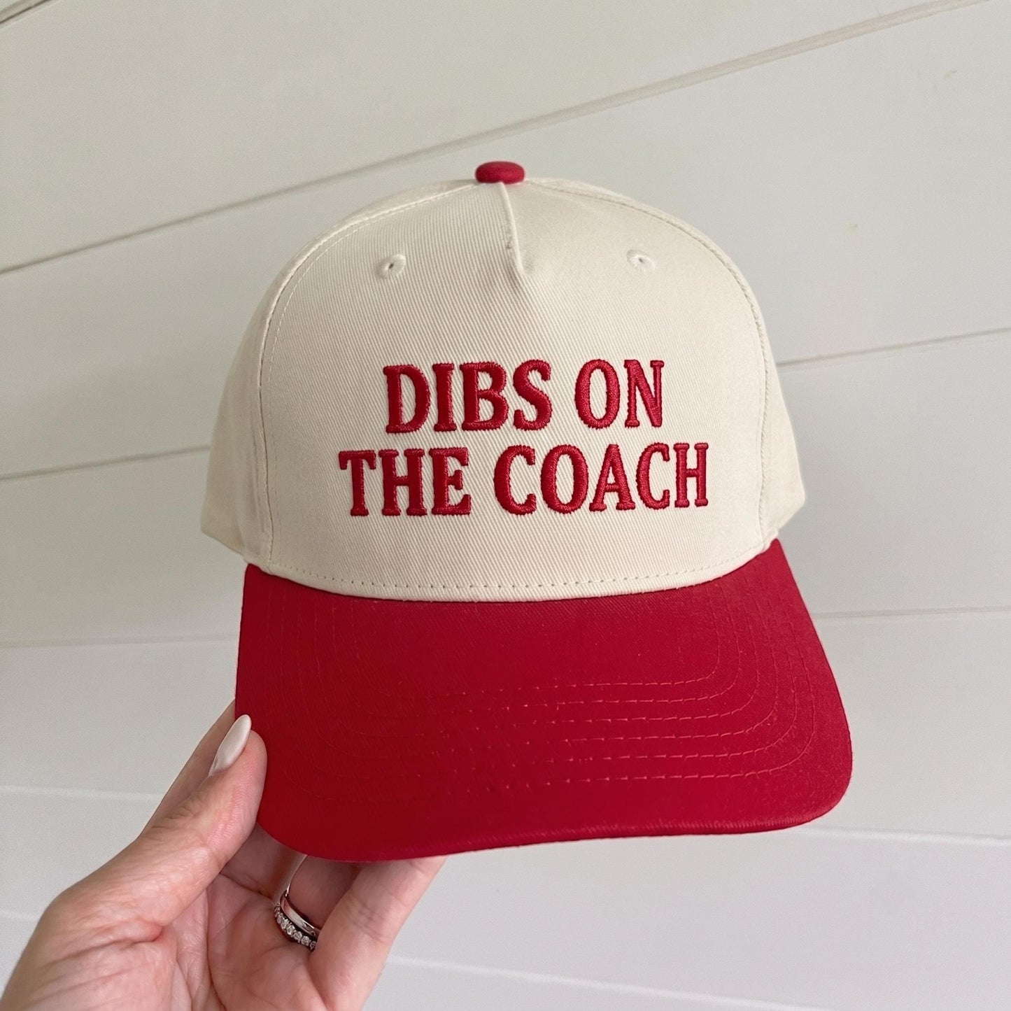 Cream and red two-tone trucker hat embroidered with DIBS ON THE COACH