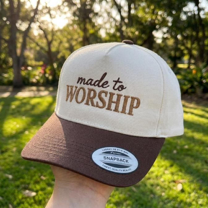 Cream and brown two-tone trucker hat embroidered with “made to WORSHIP”