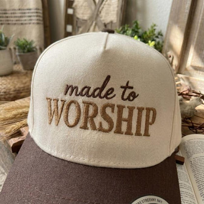 Front view of a made to worship embroidered trucker cap
