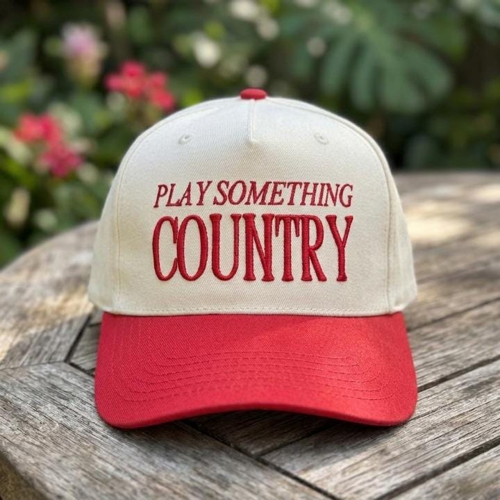 Close-up of embroidered Play Something Country lettering on a country hat