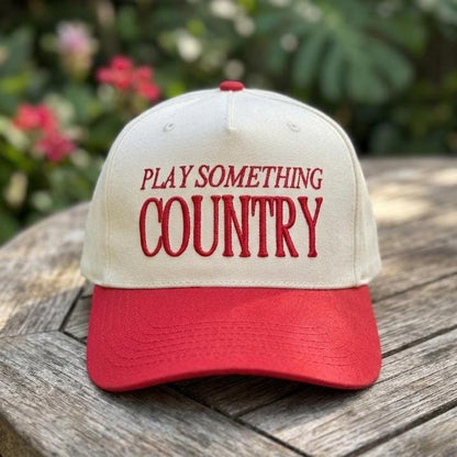 Close-up of embroidered Play Something Country lettering on a country hat