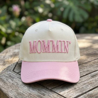 MOMMIN two-tone trucker hat with pink brim shown outdoors