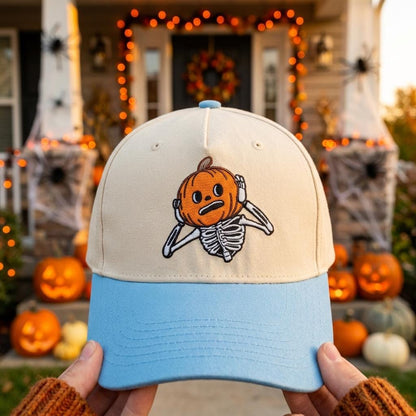 Cream and light blue Halloween cap with embroidered pumpkin skeleton design