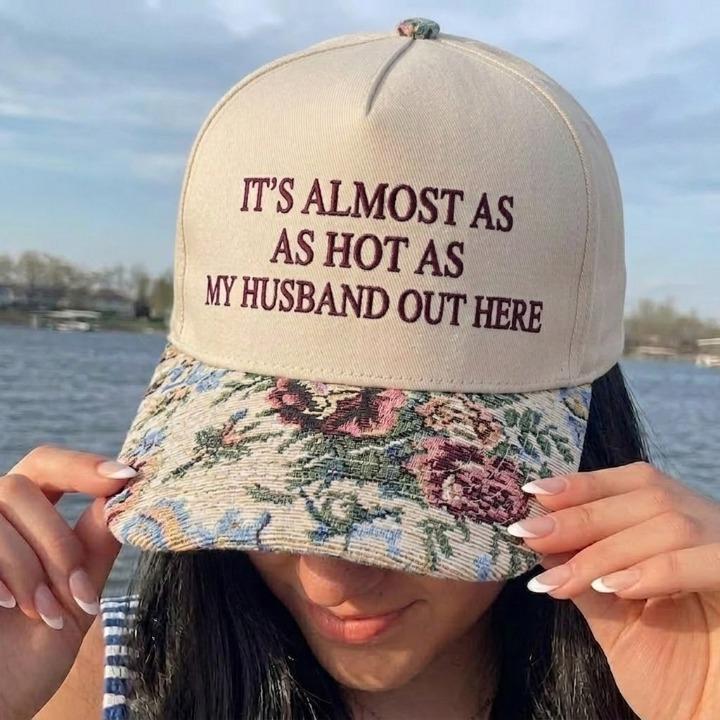 Khaki embroidered hat with the quote It’s Almost As Hot As My Husband Out Here and a floral patterned brim