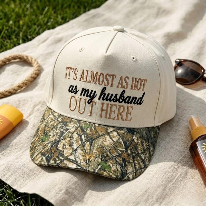 Close-up of cream embroidered hat with playful husband-themed message and camo bill