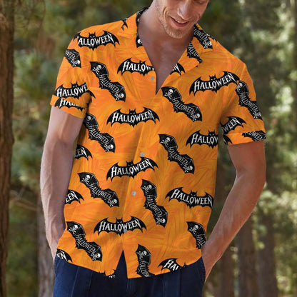 Person styling an orange bat pattern Hawaiian shirt with dark pants