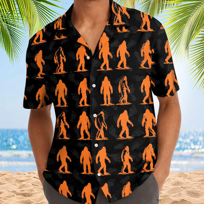 Model wearing a black orange Bigfoot Hawaiian shirt at the beach