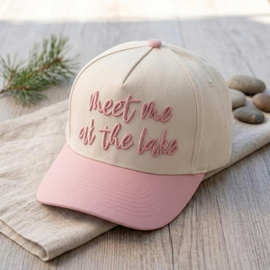 Angled view of the two-tone lake message cap with pink script embroidery