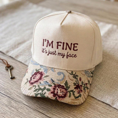 Floral brim embroidered hat displayed on a wooden table
