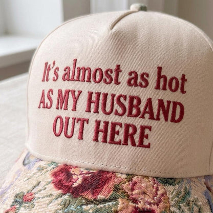 Close-up of maroon embroidered funny quote on cream hat