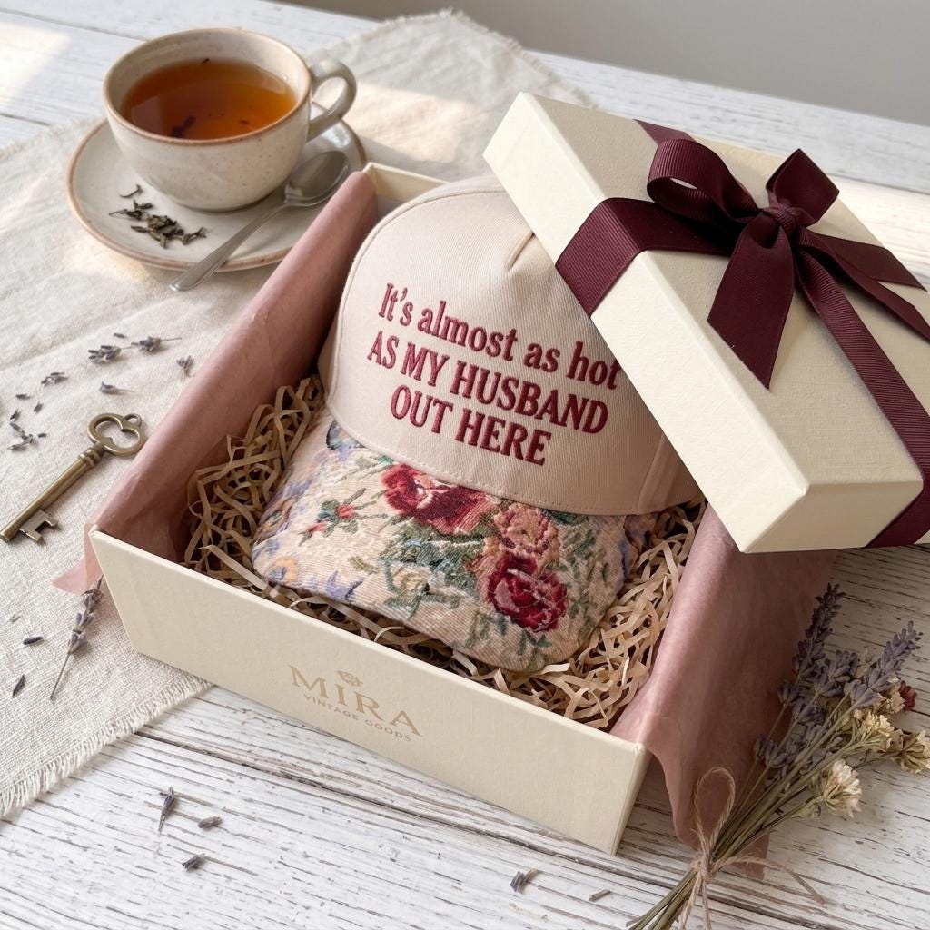 Floral embroidered hat presented in an open gift box