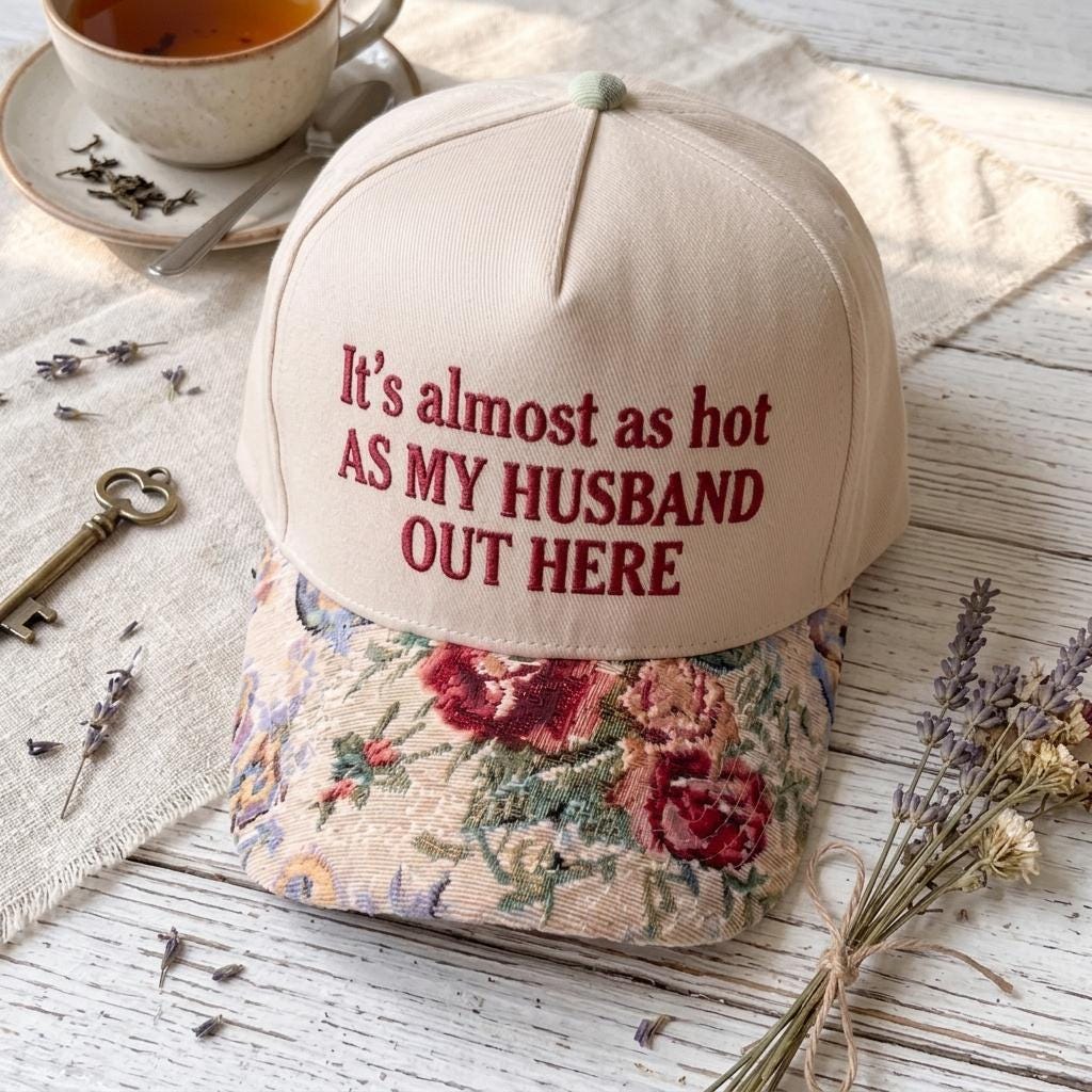 Floral brim embroidered hat styled beside tea and dried lavender