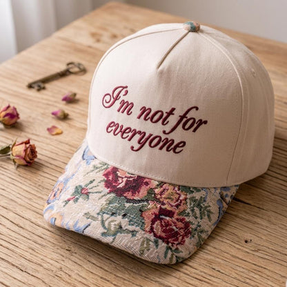 Angled view of embroidered floral brim hat on a wooden table