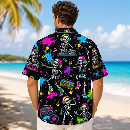 Back view of a person wearing a neon skeleton DJ Hawaiian shirt by the beach