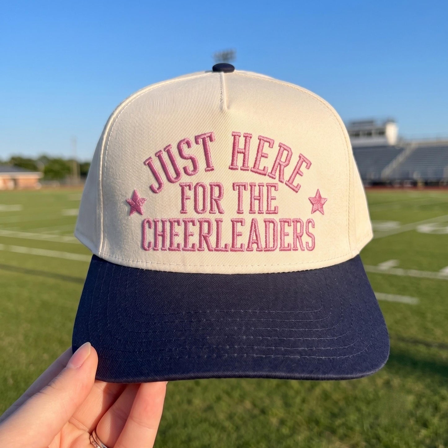 Light crown and navy brim cheerleader supporter hat with red embroidered lettering
