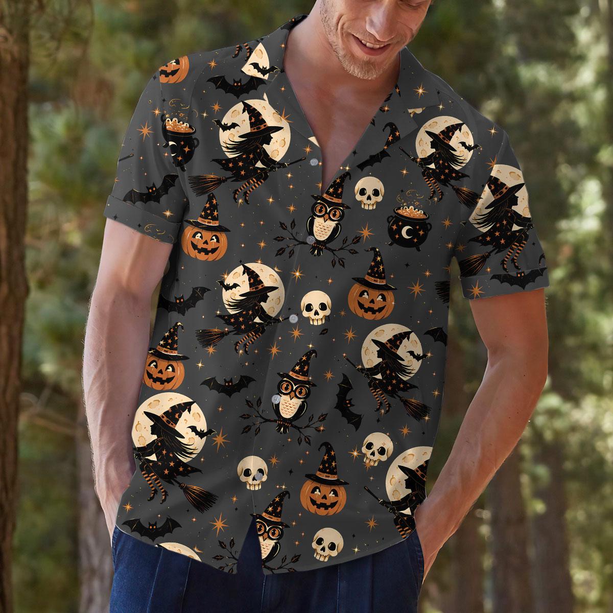 Person modeling Halloween shirt with witch, owl, pumpkin, and bat pattern